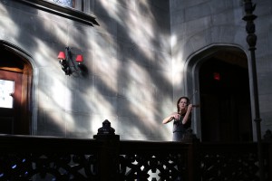 A musician playing the violin on a balcony