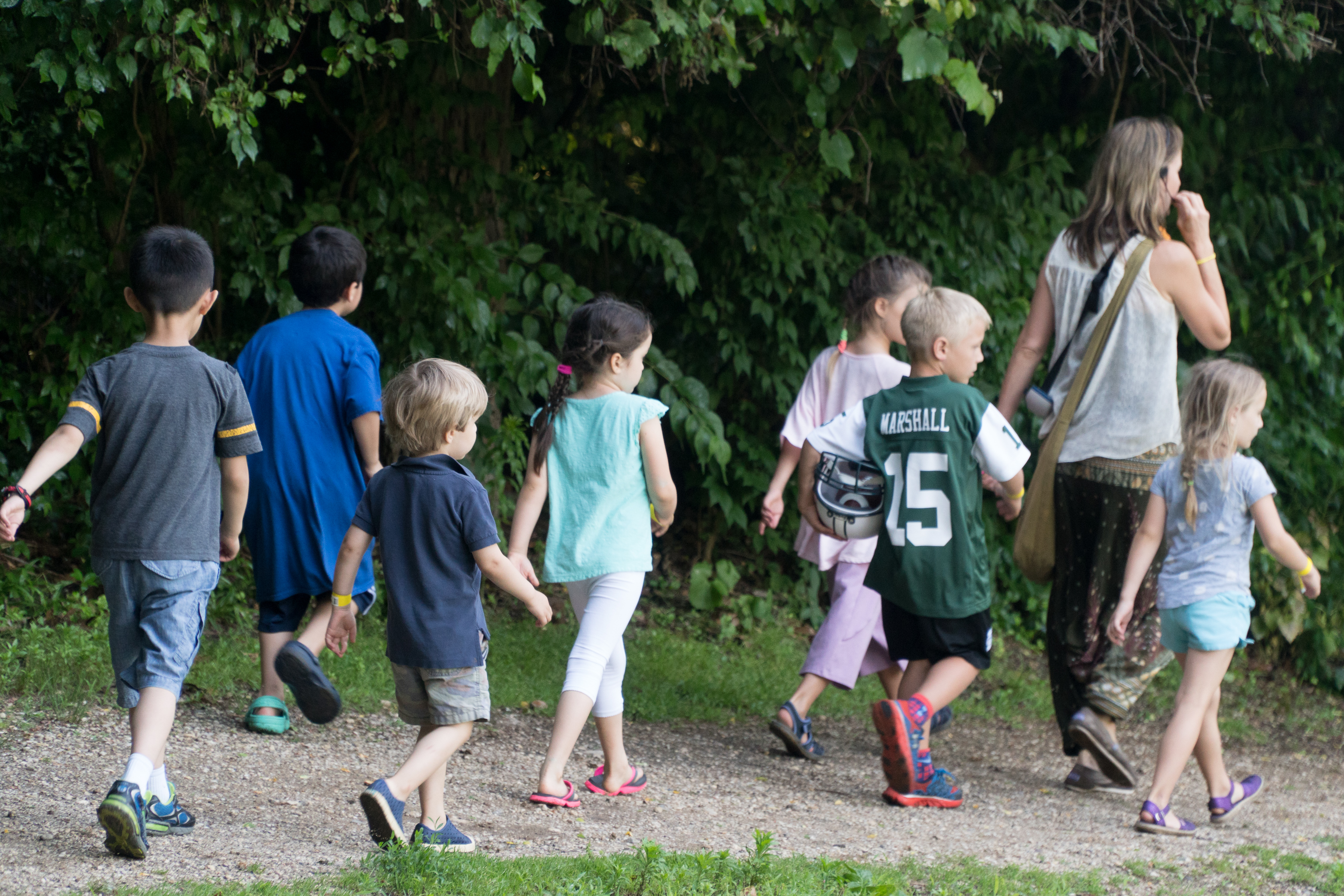 Hildur Palsdottir leads children on nature walk near the Preserve's pond.