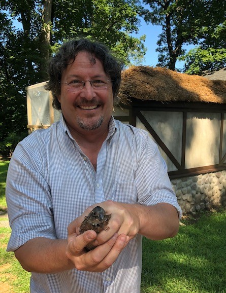 Ranger Eric Powers holds a baby quail raised at the Preserve's quail coop